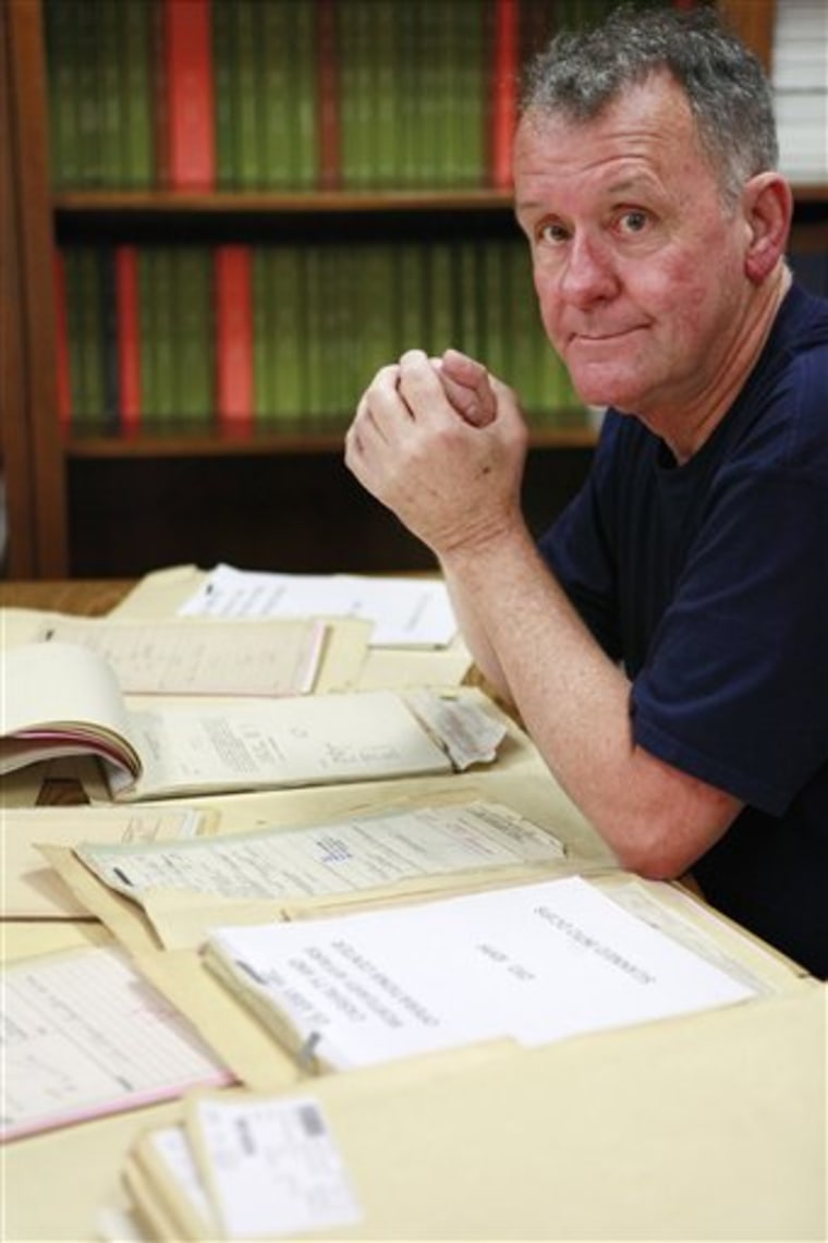 In this photo taken Tuesday, June 8, 2010, Ted Darcy, of Fall River, Mass., is surrounded by documents on his research into the identity of soldiers missing in action from WWII, while at the National Records Center in Suitland, Md. (AP Photo/Jacquelyn Martin)